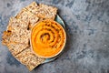 Pumpkin hummus seasoned with olive oil and black sesame seeds with whole grain crackers. Healthy vegetarian appetizer or snack. Royalty Free Stock Photo