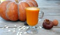 Pumpkin juice in a glass for a weight loss program. Autumn vitamin still life.