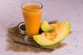 Pumpkin juice in a high glass on a white background. Concept of healthy autumn drinks.