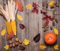 Pumpkin, nuts, acorns, corn and autumn leaves on a old weathered wood. Fall concept