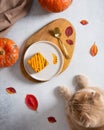 Pumpkin orange cheesecake, brownie with chocolate for Thanksgiving and cat`s paws on the table. Pumpkins and autumn leaves on the Royalty Free Stock Photo