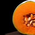 Pumpkin with orange flesh on the wooden board Royalty Free Stock Photo