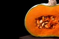 Pumpkin with orange flesh on the wooden board Royalty Free Stock Photo