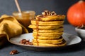 Pumpkin pancakes with caramel sauce and pecan nuts Royalty Free Stock Photo