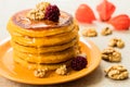 Pumpkin pancakes with honey and nuts, berries. End of seasonal autumn breakfast. Royalty Free Stock Photo