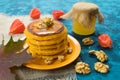 Pumpkin pancakes with honey and nuts on a blue background. Royalty Free Stock Photo