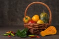 Pumpkin pepper tomato in a basket on a background of pepper and pumpkin