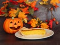 Pumpkin Pie Slice with Ceramic Orange Halloween Pumpkin Royalty Free Stock Photo