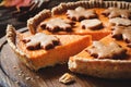Pumpkin pie sliced on wooden board. Closeup view Royalty Free Stock Photo