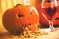 Pumpkin puking with pumpkin seeds on wood table, glass of wine, vintage effect