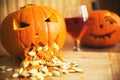 Pumpkin puking with pumpkin seeds on wood table, glass of wine, vintage effect