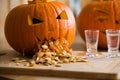 Pumpkin puking with pumpkin seeds on wood table, vodka