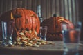 Pumpkin puking with pumpkin seeds on wood table, vodka, hdr effect