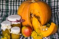 Pumpkin and pumpkin jam, puree or sauce on green with white tablecloth. Autumn still life. Royalty Free Stock Photo