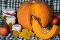 Pumpkin and pumpkin jam, puree or sauce on green with white tablecloth. Autumn still life. Royalty Free Stock Photo