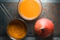 Pumpkin, pumpkin soup bowl and pumpkin puree in a saucepan Royalty Free Stock Photo