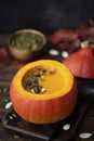 pumpkin puree soup in pumpkin with seeds and sesame seeds