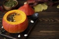 pumpkin puree soup in pumpkin with seeds and sesame seeds