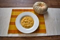 Pumpkin risotto in a white plate with the pumpkin decoration Royalty Free Stock Photo