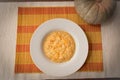Pumpkin risotto in a white plate with the pumpkin decoration Royalty Free Stock Photo