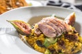 Pumpkin risotto roasted duck breast figs zucchini and min leaves. italian or mediterranean cuisine