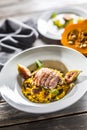 Pumpkin risotto roasted duck breast figs zucchini and min leaves. italian or mediterranean cuisine