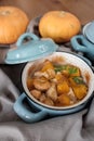 Pumpkin roast in a blue pan on a wooden table Royalty Free Stock Photo