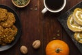 Pumpkin Roll and pumpkin cookies on the wooden table with cup of coffee. Holiday composition