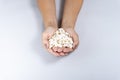 Pumpkin seed. Female hand holding pumpkin toast leaning against gray background