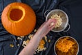 Pumpkin seed harvesting, womanÃ¢â¬â¢s hands sorting seeds and pumpkin guts