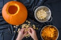 Pumpkin seed harvesting, womanÃ¢â¬â¢s hands sorting seeds and pumpkin guts