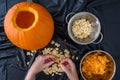 Pumpkin seed harvesting, womanÃ¢â¬â¢s hands sorting seeds and pumpkin guts