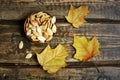 Pumpkin seeds and autumn maple leaves