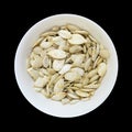 Pumpkin seeds bowl isolated on black Royalty Free Stock Photo