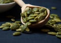 Pumpkin seeds in a white bowl and wooden spoon Royalty Free Stock Photo