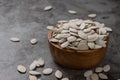 Pumpkin seeds in wooden bowl on the cement floor