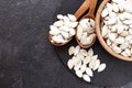 Pumpkin seeds and a wooden spoon on a dark table. Black slateboard with wooden bowl. Copy space Royalty Free Stock Photo