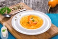 Pumpkin and Shrimp Soup, seeds and fresh cream, top view Royalty Free Stock Photo