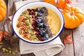 Pumpkin smoothie bowl with chia seeds, pecans, cranberries Royalty Free Stock Photo