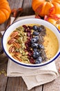 Pumpkin smoothie bowl with chia seeds, pecans, cranberries Royalty Free Stock Photo