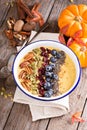 Pumpkin smoothie bowl with chia seeds, pecans, cranberries Royalty Free Stock Photo