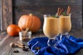 Pumpkin smoothie with cinnamon and granola on the old wooden background. Royalty Free Stock Photo