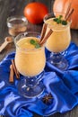 Pumpkin smoothie with cinnamon and granola on the old wooden background. Royalty Free Stock Photo