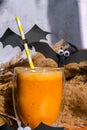 Pumpkin smoothie spiced latte. Fall Drinks for Halloween decorations with bat on straw. Holiday drink Autumn coffee with Royalty Free Stock Photo