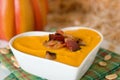 Pumpkin soup with bacon in heart shaped bowl