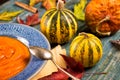 Pumpkin soup in a blue ceramic plate and a spoon Vintage tinted Royalty Free Stock Photo