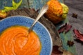 Pumpkin soup in a blue ceramic plate and a spoon Vintage tinted Royalty Free Stock Photo