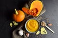 Pumpkin soup in a bowl with fresh pumpkins, garlic, croutons and spices Royalty Free Stock Photo