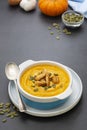 Pumpkin soup in a bowl,with fresh pumpkin seeds. Autumn foods. Healthy, vegetarian food, dark background Royalty Free Stock Photo