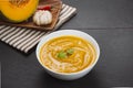 Pumpkin soup in a bowl with garlic and parsley herbs Royalty Free Stock Photo